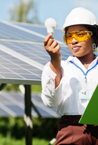 Africa solar energy concept African american technician check the maintenance of the solar panels. Black woman engineer at solar station.